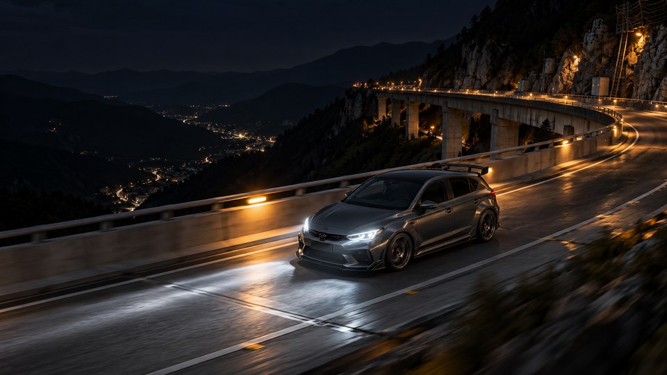 A graphite unbranded tuner hatchback speeds across a high mountain viaduct at night under sparse maintenance lights, seen from an elevated three-quarter angle.